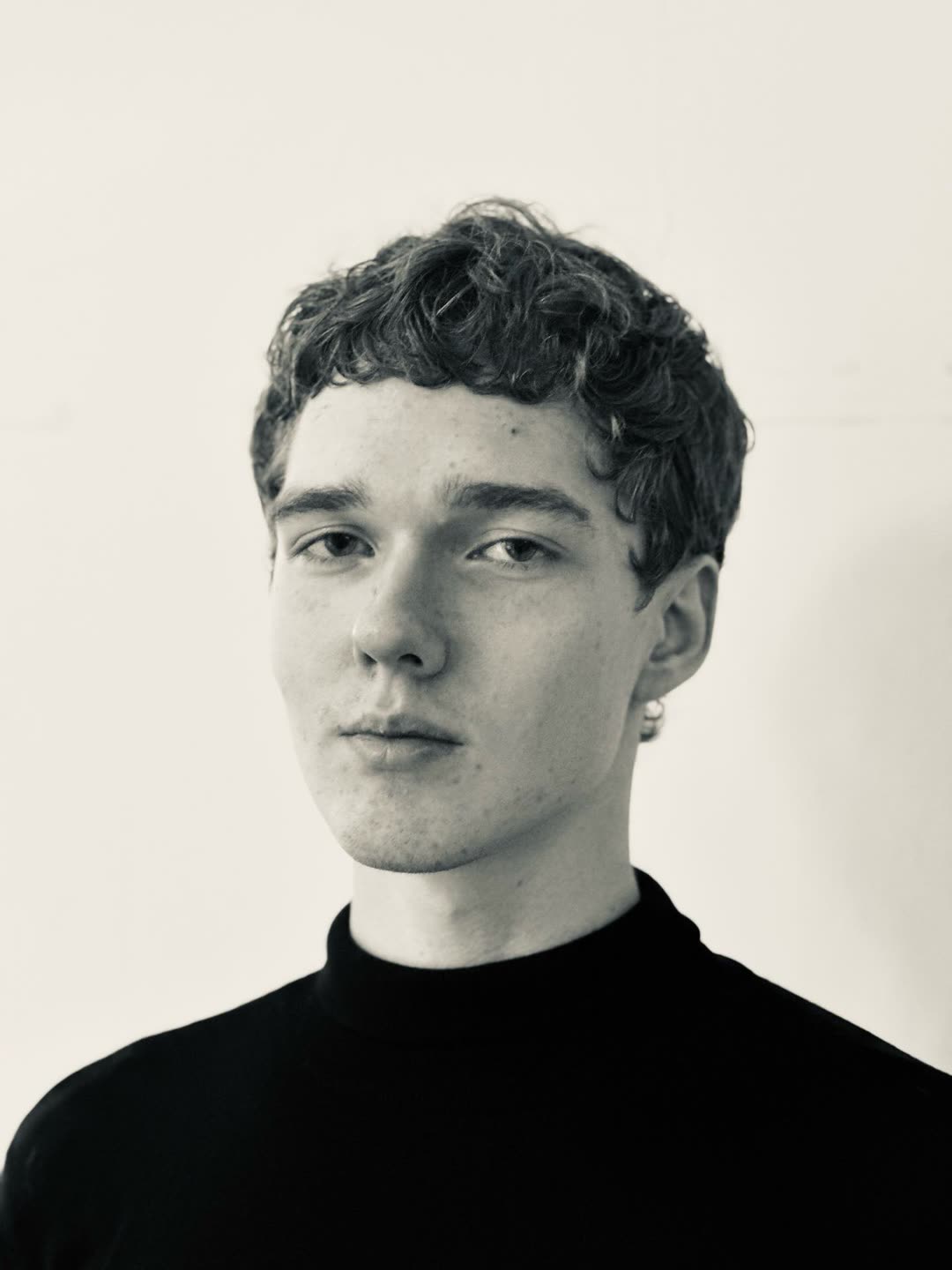 Black and white portrait, hair cut short and textured